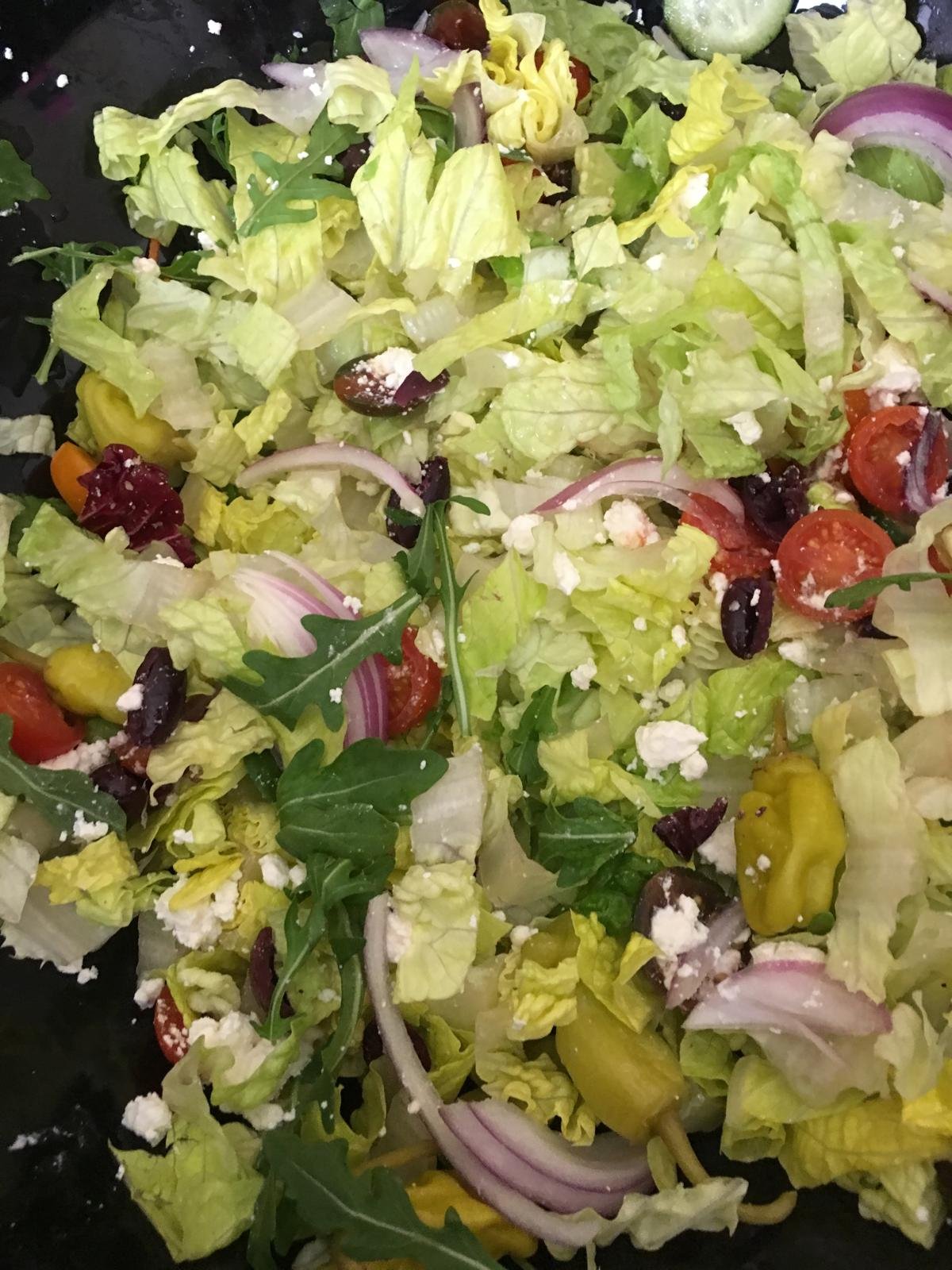 Chopped salad with feta, olives and pepperoncini.