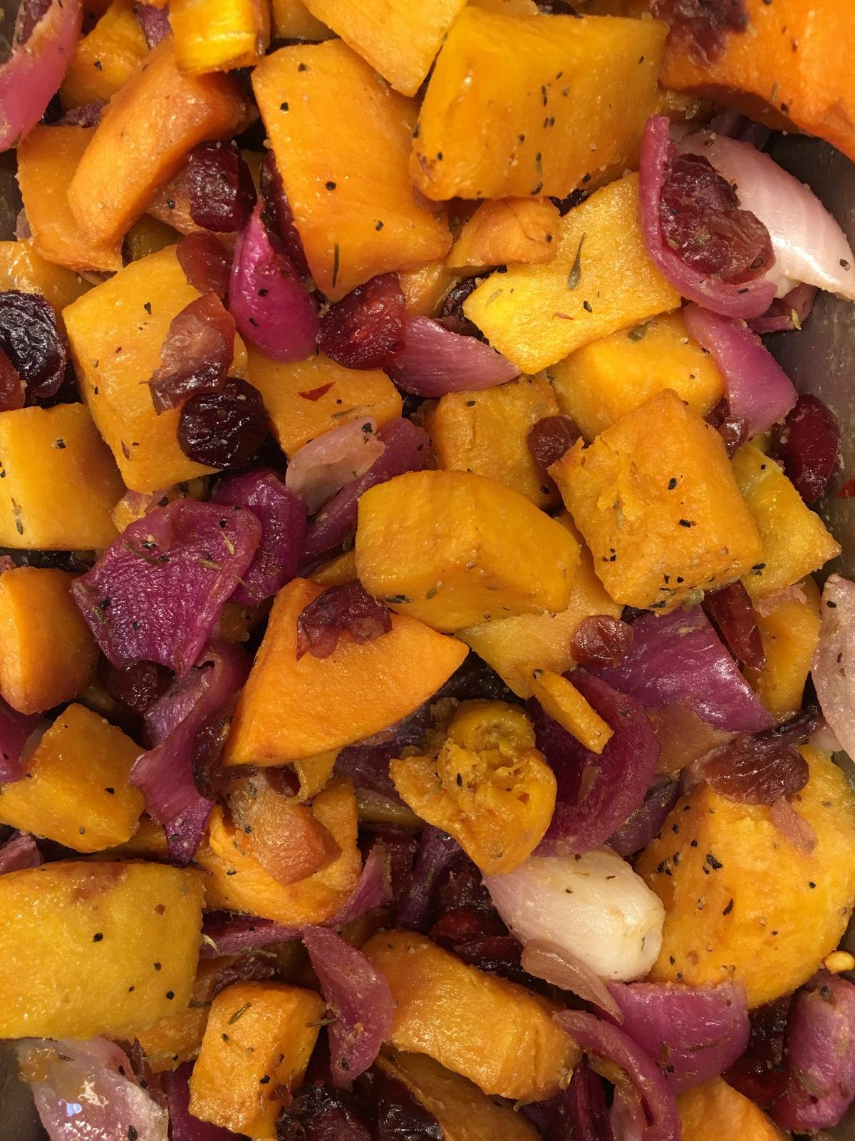 Roasted butternut squash with red onion and cranberries.
