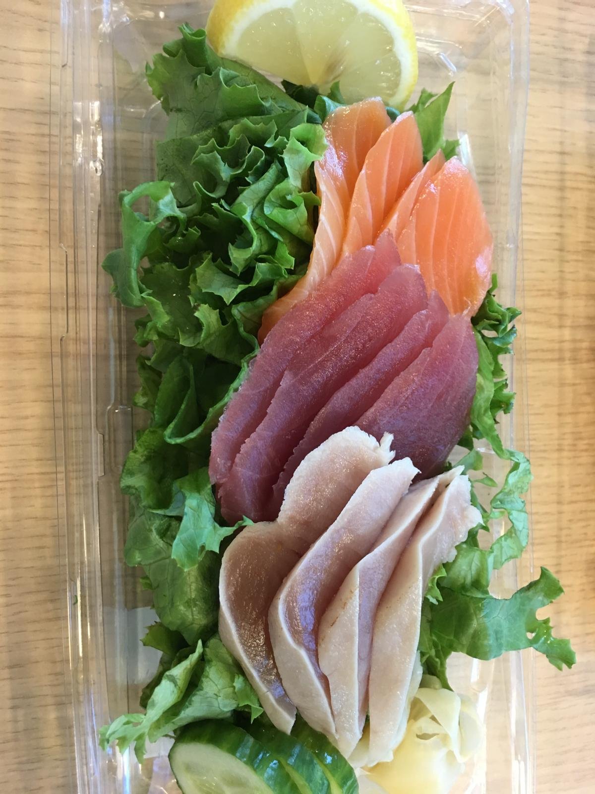 Sliced sashimi fanned over lettuce.
