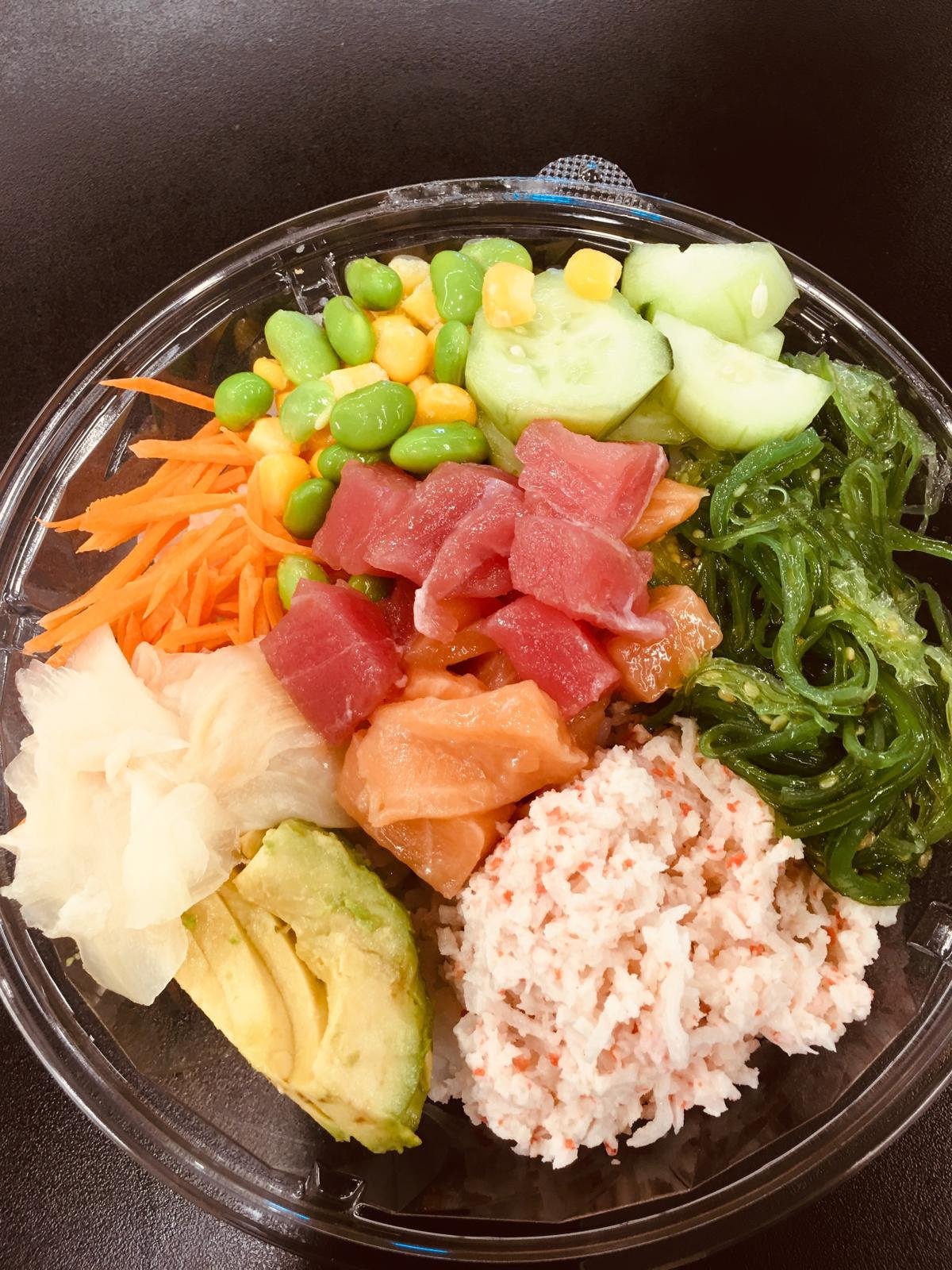 A poke bowl with tuna, salmon, crab, edamame and cucumber.